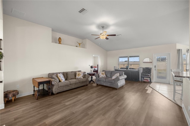 living room featuring hardwood / wood-style flooring, ceiling fan, and high vaulted ceiling