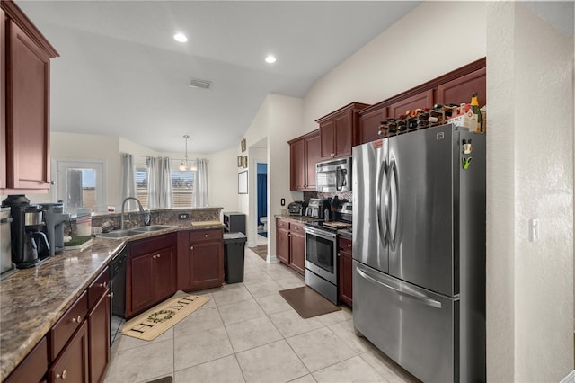 kitchen with sink, hanging light fixtures, vaulted ceiling, tasteful backsplash, and stainless steel appliances