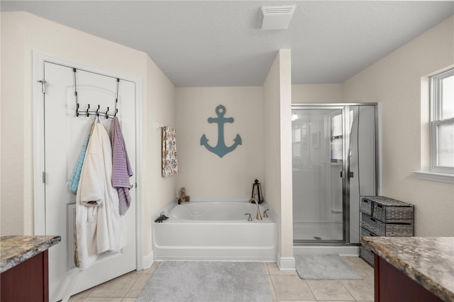 bathroom with tile patterned flooring, vanity, a textured ceiling, and shower with separate bathtub