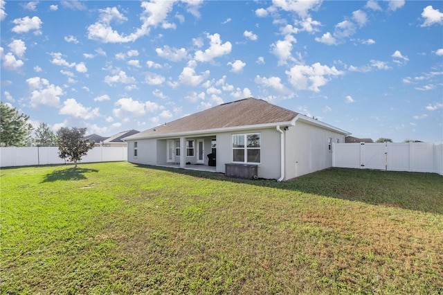 rear view of house featuring a patio area and a yard