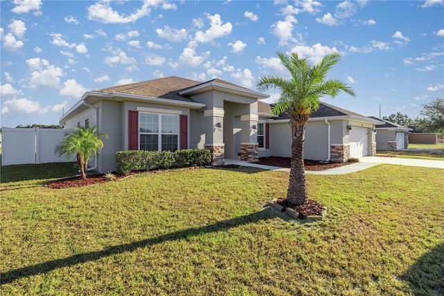 view of front of property with a garage and a front lawn