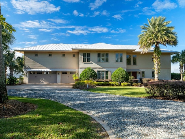 view of front facade with a front yard and a garage