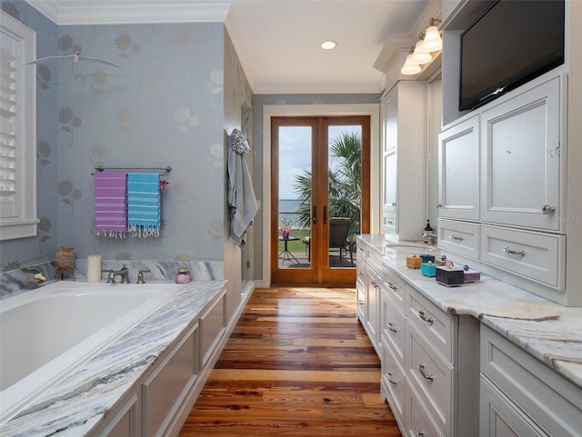 bathroom with ornamental molding, wood-type flooring, shower with separate bathtub, and french doors