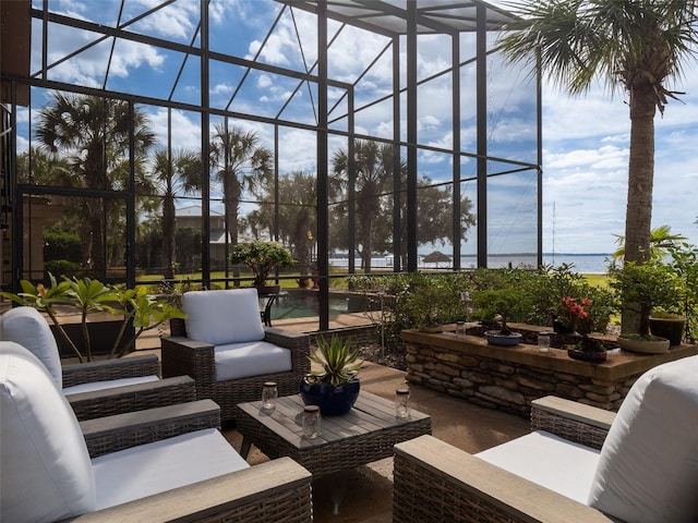 sunroom / solarium featuring a water view and a healthy amount of sunlight