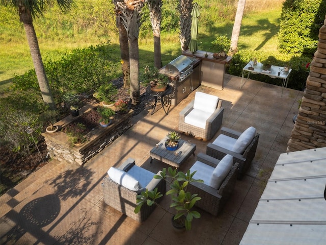 view of patio / terrace with a grill, an outdoor living space, and an outdoor kitchen