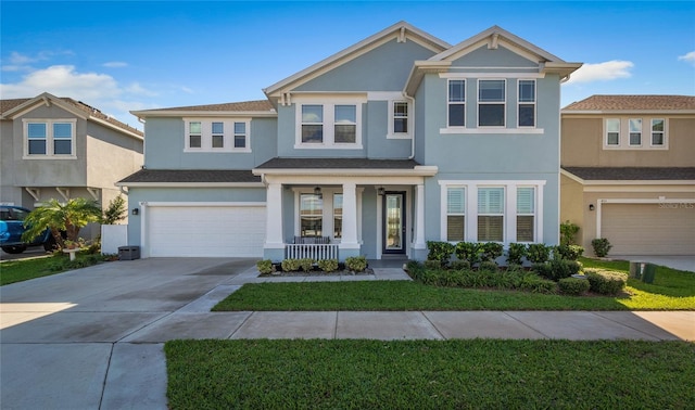 view of front of property featuring an attached garage, covered porch, driveway, and stucco siding