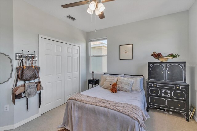 bedroom featuring a closet, visible vents, ceiling fan, and carpet floors