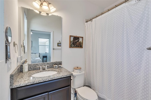 ensuite bathroom featuring vanity, toilet, and ensuite bathroom