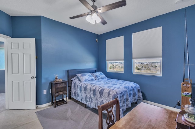 bedroom featuring a ceiling fan, carpet, and baseboards