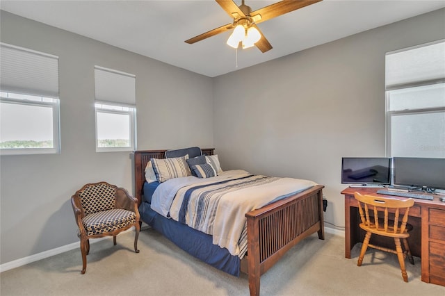 carpeted bedroom featuring ceiling fan and baseboards