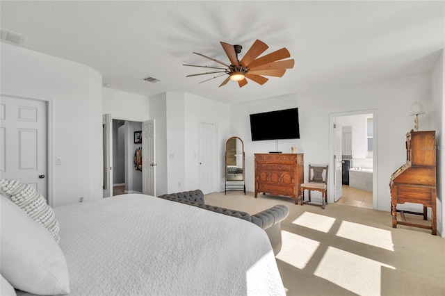 bedroom with visible vents, light colored carpet, a ceiling fan, and connected bathroom