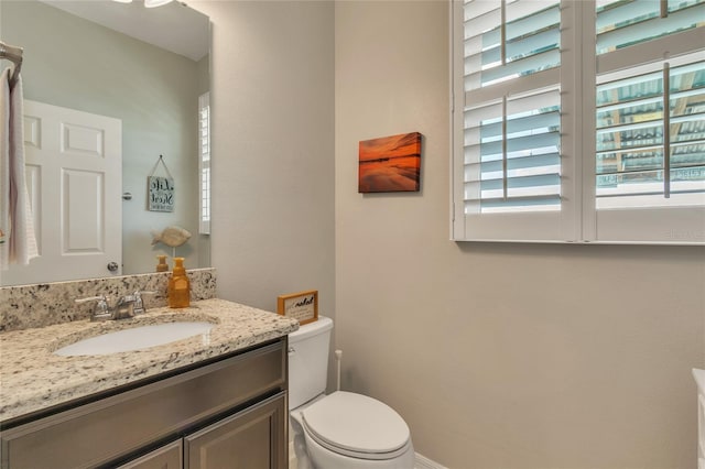 half bathroom featuring toilet and vanity