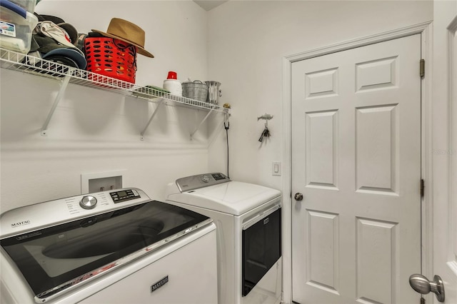 washroom with washer and clothes dryer and laundry area