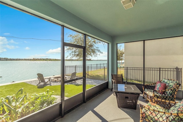 sunroom / solarium featuring a water view