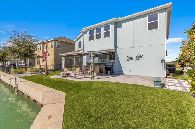 back of house with fence, central AC, stucco siding, a lawn, and a patio