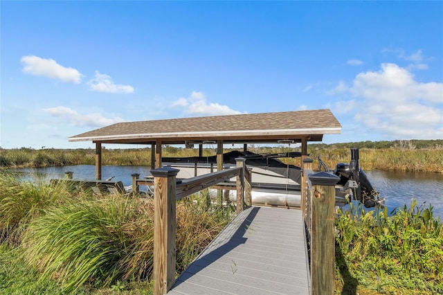 dock area featuring boat lift and a water view