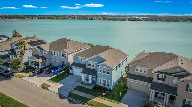 bird's eye view featuring a residential view and a water view