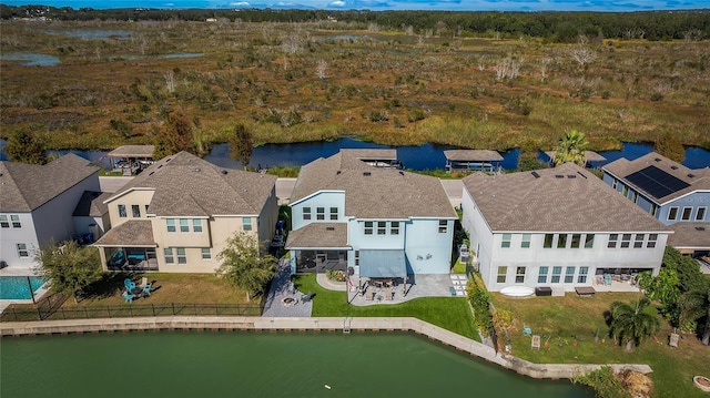 drone / aerial view with a residential view and a water view