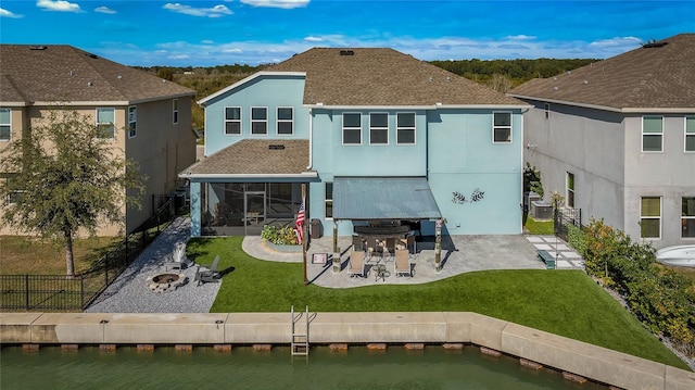 back of house with stucco siding, a patio, a fenced backyard, a yard, and roof with shingles