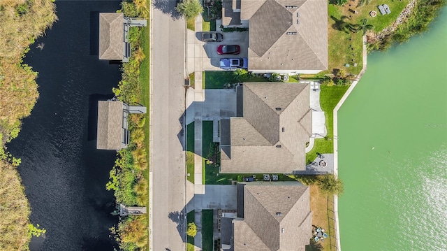 drone / aerial view featuring a water view and a residential view