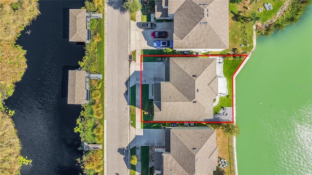 birds eye view of property with a water view