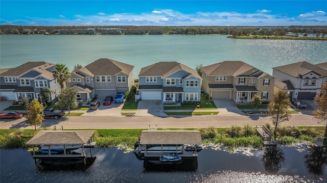 drone / aerial view with a residential view and a water view