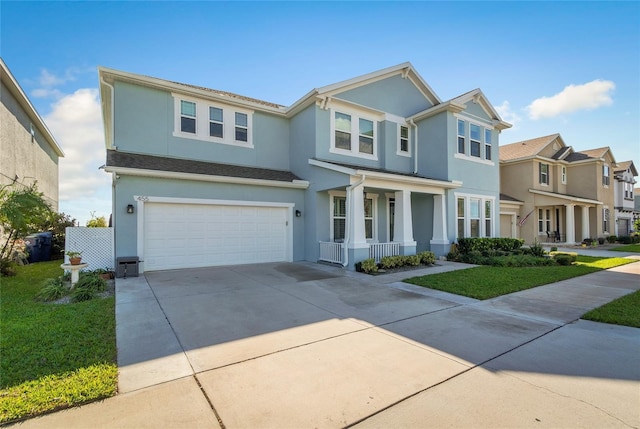 view of front of home with stucco siding, a front lawn, driveway, a porch, and a garage