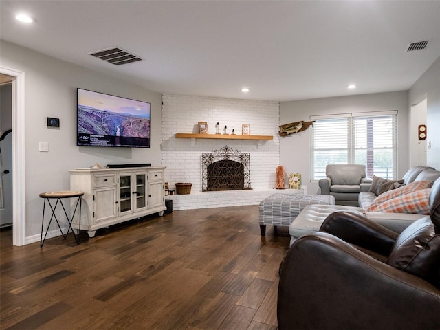 living room featuring dark hardwood / wood-style flooring and a fireplace