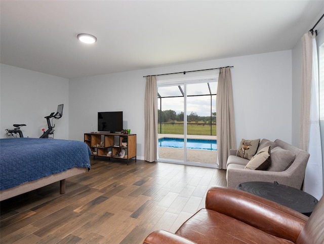 bedroom with hardwood / wood-style flooring and access to exterior