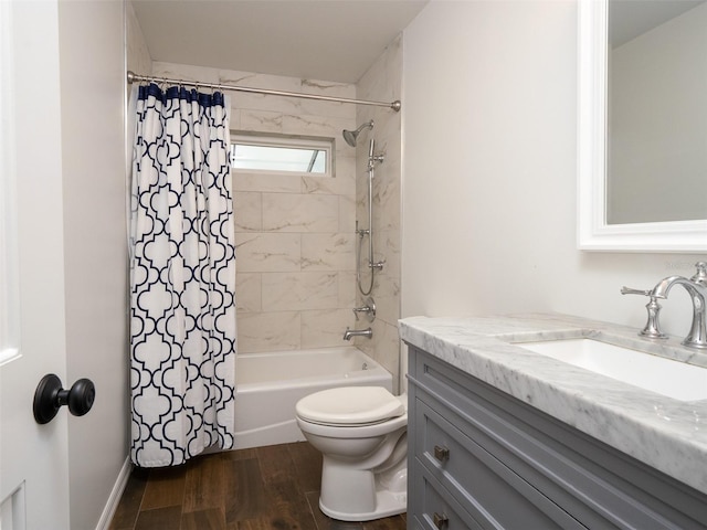 full bathroom featuring hardwood / wood-style floors, vanity, toilet, and shower / tub combo with curtain