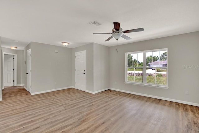 unfurnished room with light wood-type flooring and ceiling fan