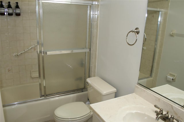 full bathroom featuring vanity, toilet, and bath / shower combo with glass door