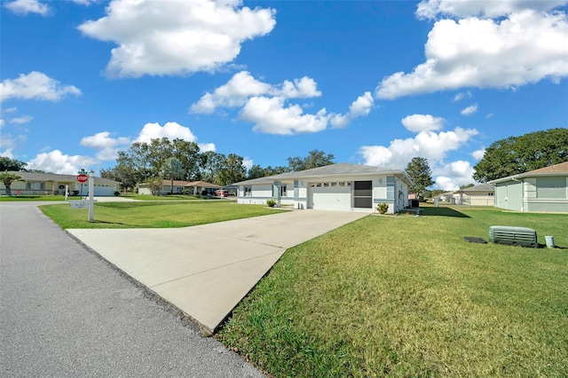 ranch-style home featuring a garage and a front lawn