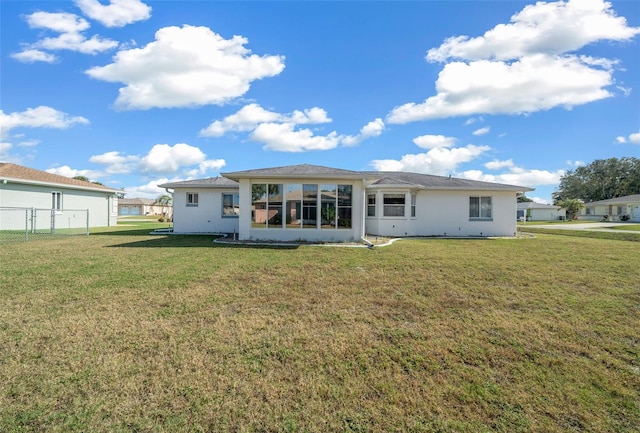 rear view of property featuring a yard