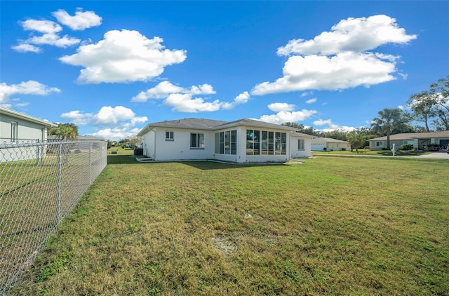 rear view of house with a yard