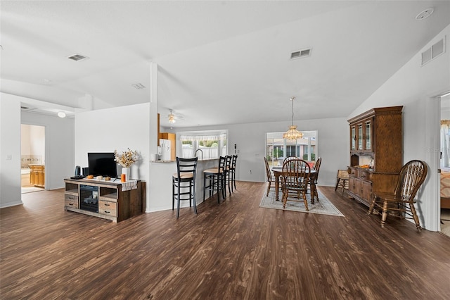 dining space featuring ceiling fan, dark hardwood / wood-style flooring, and vaulted ceiling