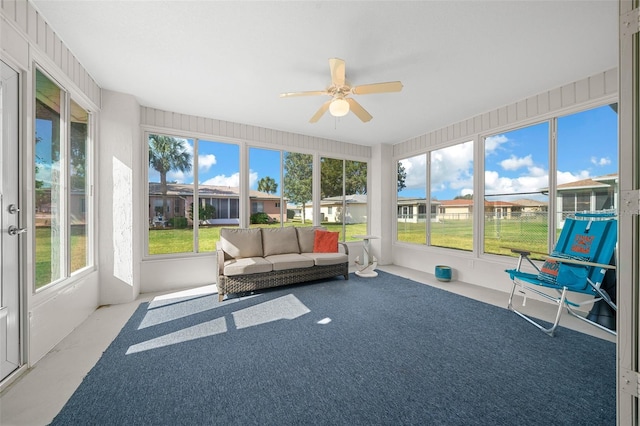 sunroom with ceiling fan and a healthy amount of sunlight