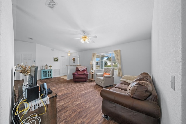 living room with ceiling fan, vaulted ceiling, and hardwood / wood-style flooring