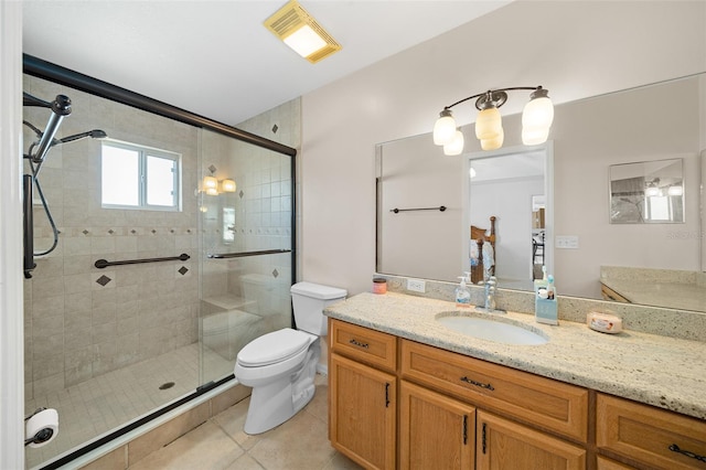 bathroom featuring toilet, vanity, tile patterned floors, and an enclosed shower