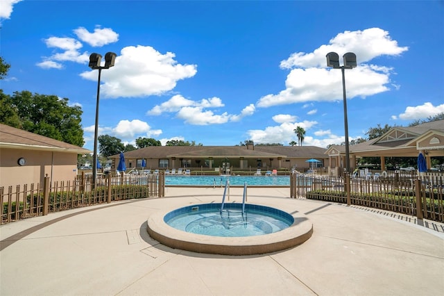 view of pool featuring a hot tub