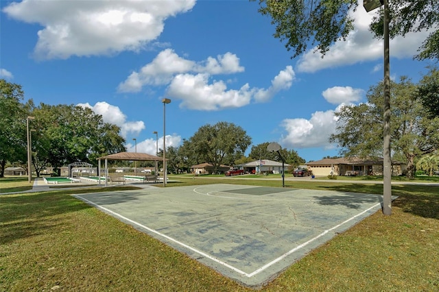 view of community featuring a gazebo, a lawn, and basketball court