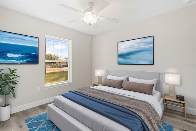 bedroom with ceiling fan and light wood-type flooring