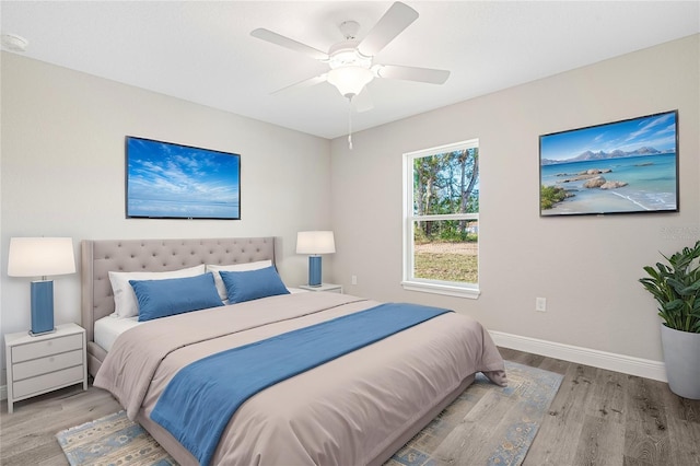 bedroom with ceiling fan and light hardwood / wood-style floors