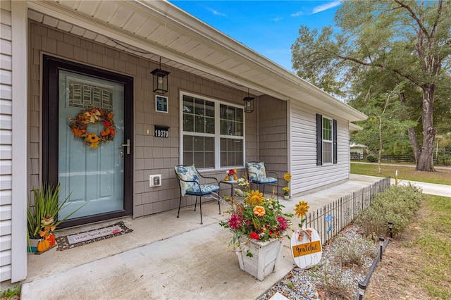 property entrance with covered porch