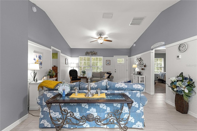 living room featuring a wealth of natural light, ceiling fan, and high vaulted ceiling