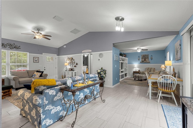 living room featuring vaulted ceiling and ceiling fan