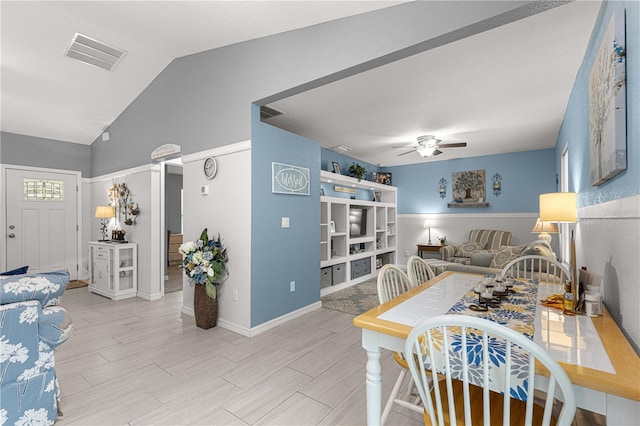 dining space with ceiling fan, light hardwood / wood-style floors, and lofted ceiling