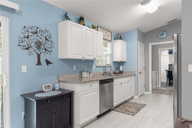 kitchen with dishwasher, light stone counters, white cabinetry, and sink