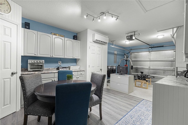 interior space featuring a garage door opener and a wall mounted air conditioner