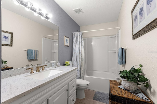 full bathroom featuring vanity, shower / bath combination with curtain, hardwood / wood-style flooring, toilet, and a textured ceiling